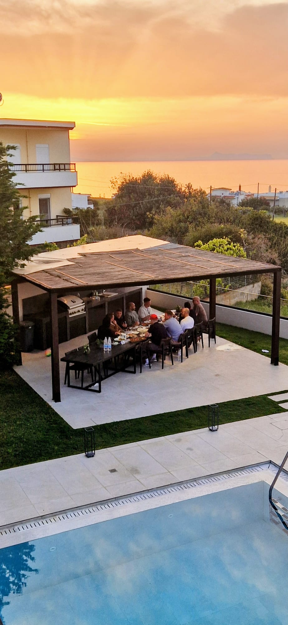 Dinner together on a terrace at sunset