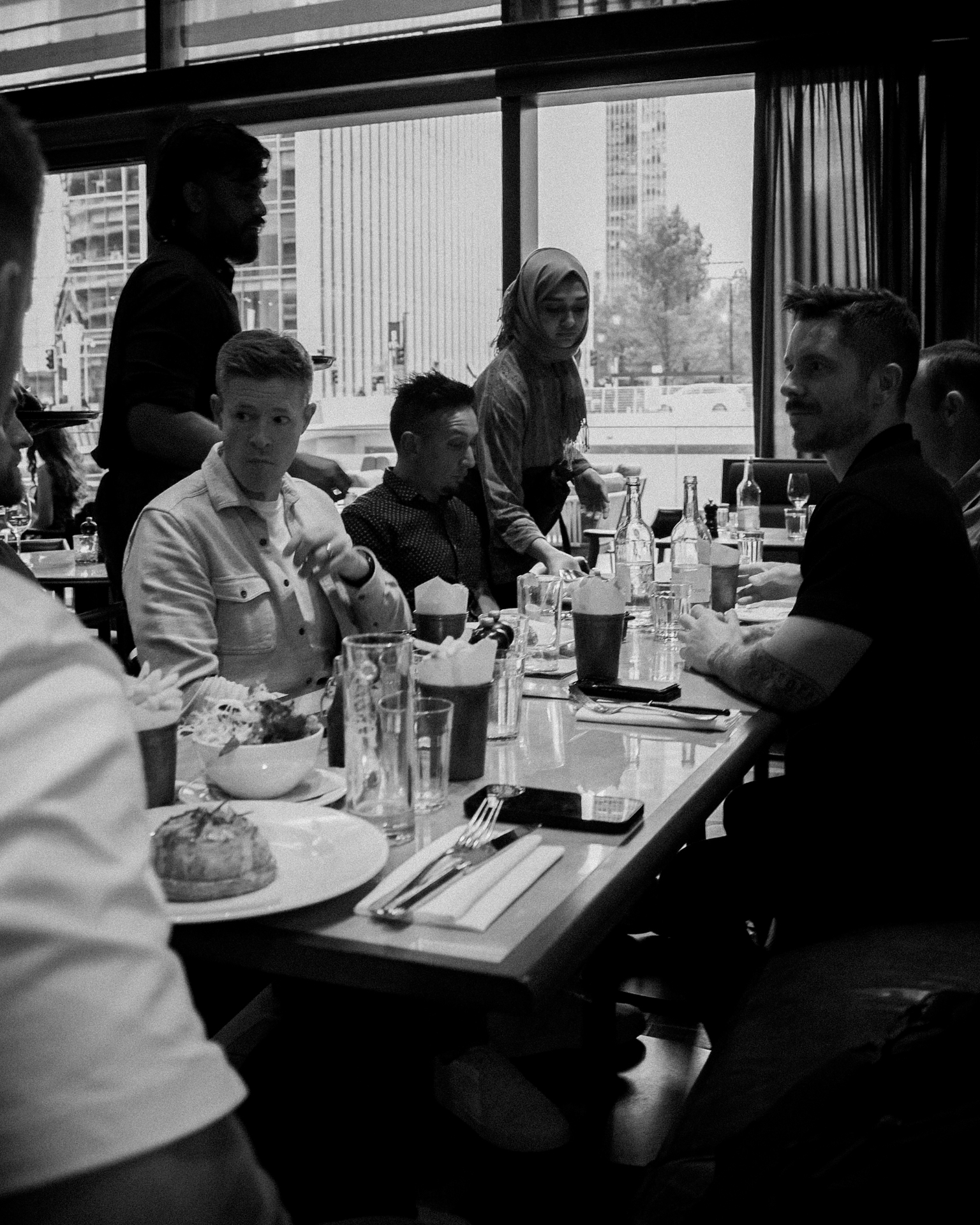 A long table of founders at dinner being served
